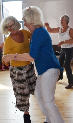 Two participants dancing together in a hall