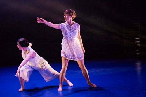 Two figures in movement dressed in white