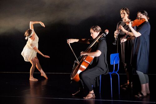 A blindfolded figure in movement and three musicians playing instruments