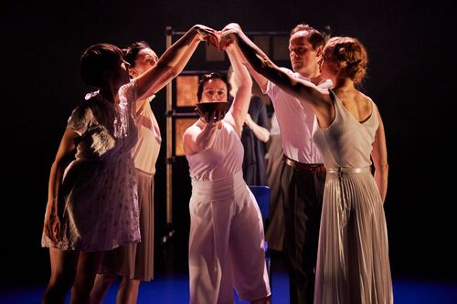 Five figures in movement with hands joined in an arch