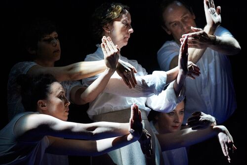 Five figures in movement with hands connecting