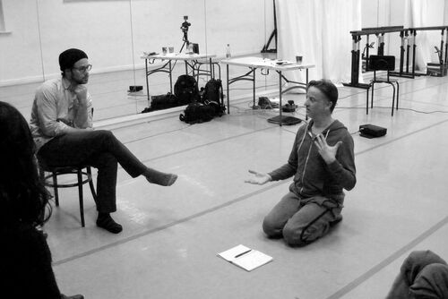 David Bolger seated on the floor in conversation with Christopher Ash in a chair