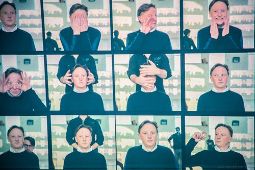 Still images of David Bolger projected on a wall in a grid