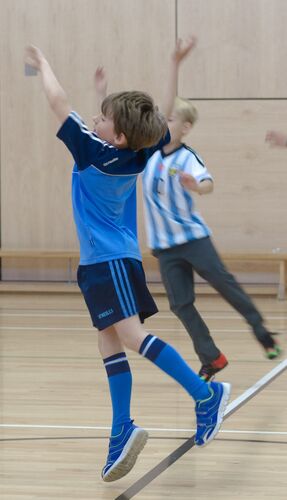 Two young boys mid jump
