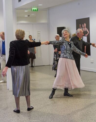 Participants in movement with two swinging from each other's hands