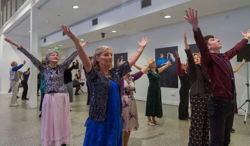 Participants with their arms stretched open over their heads