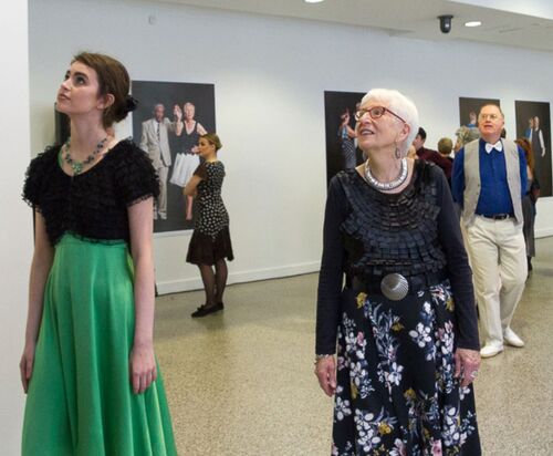 Participants looking at the images on the gallery walls
