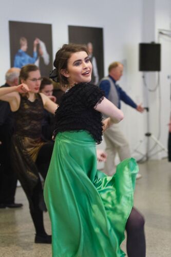 A participant in a bright green dress in movement