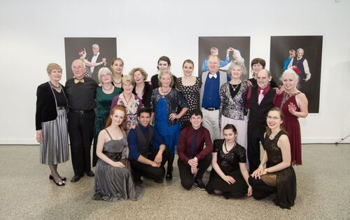 Participants posing in line for a group photo and smiling to camera