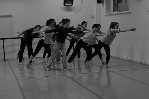 Participants in movement in the corner of a studio