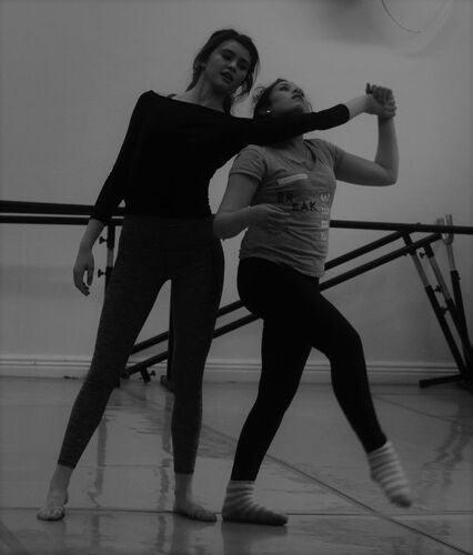 Two figures in movement in a studio