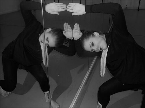 A participant in movement against a mirror