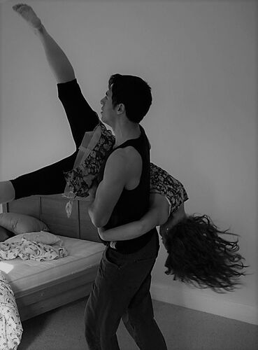 Two participants mid-lift in black and white
