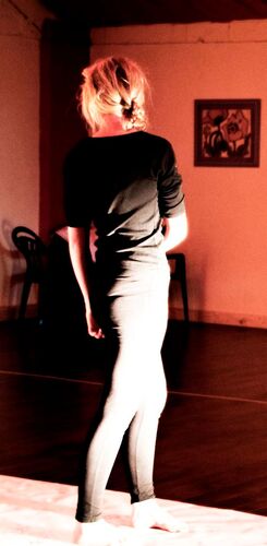 A figure in movement with light cast on their body