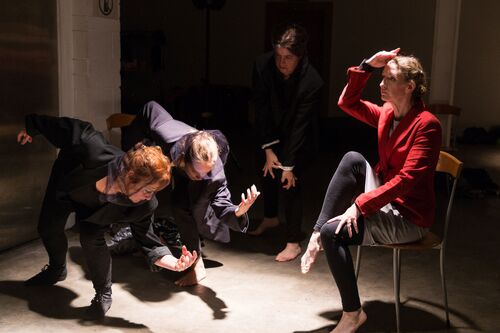 Four participants in movement, one in a seated position