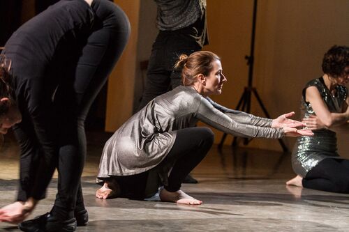 Participants in movement in silver costumes