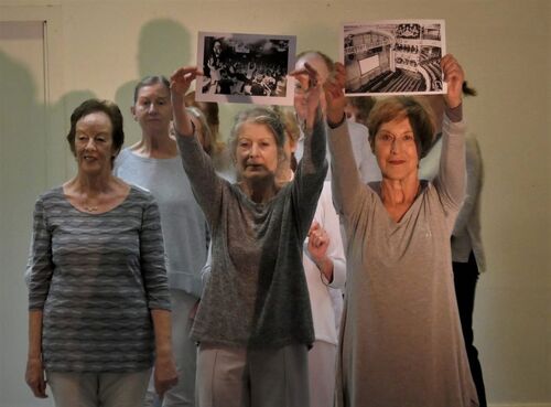 Two participants holding black and white images aloft
