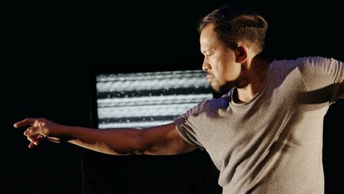 Donking Rongavilla on stage with projections in the background