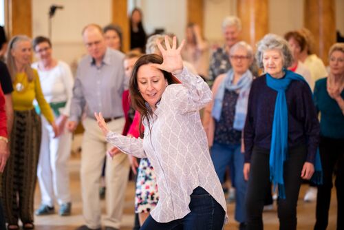 Emma O'Kane in movement with participants watching