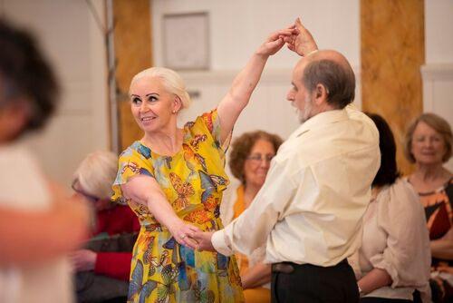 Two participants holding hands to create a circle
