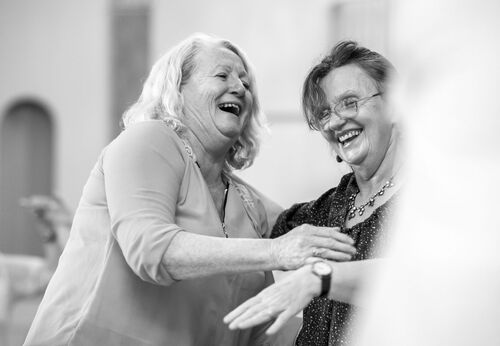 Two participants laughing in black and white