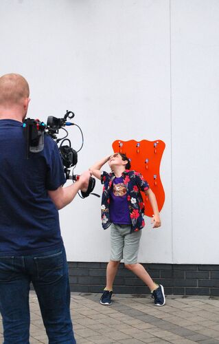 A young participant dancing during filming