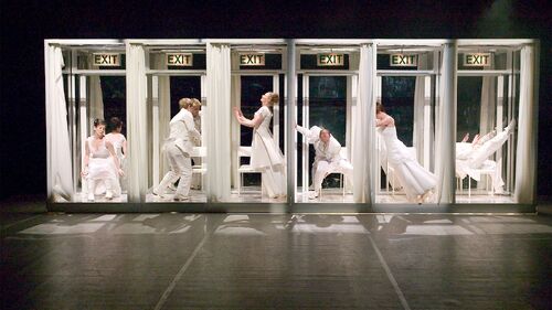 Six dancers move in six separate cubicles