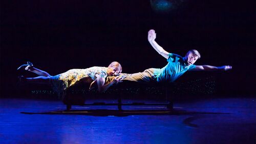 Two figures horizontal across a stage to look like they're swimming