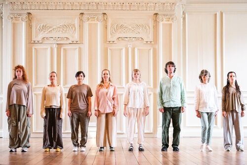 Dancers in a row standing on stage