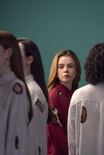 A woman looking through other three people