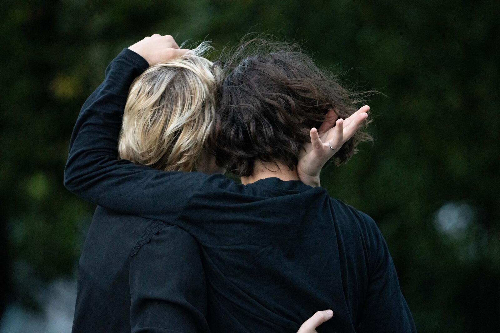 Two heads of women leaning against each other