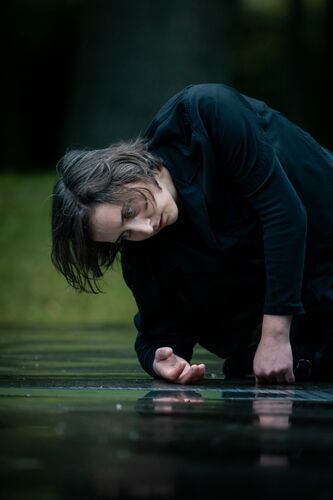 A woman bent over the ground