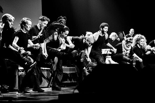 People dancing on the stage holding their hands