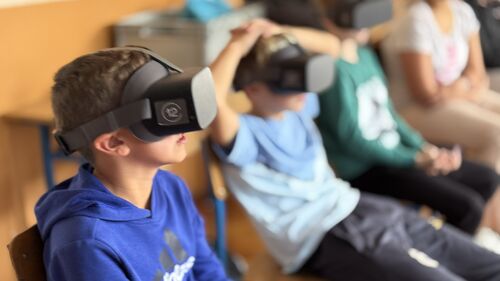 A boy in VR goggles.JPEG