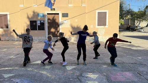 The kids and a teacher dancing on the street.JPEG