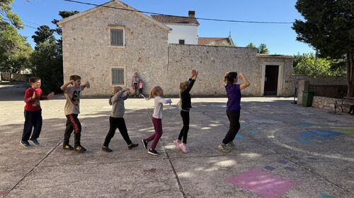 The kids and a teacher dancing on the street.JPEG